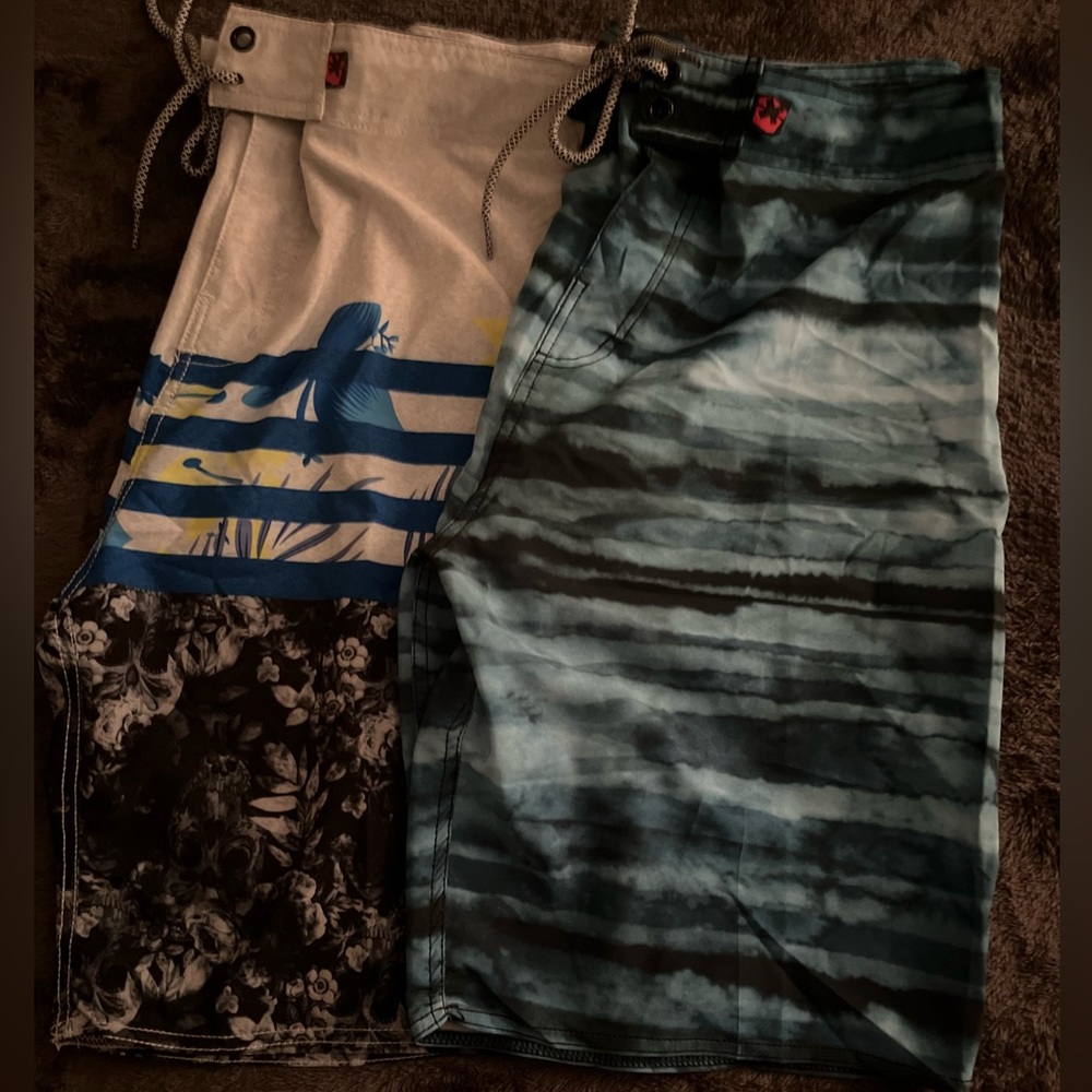 Two pair of swim trunks . Both pair are new with tags .
